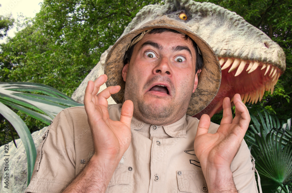 Fototapeta premium Man with helmet is running away from scary dinosaur