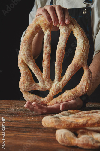 Hands men holding fougas bread photo