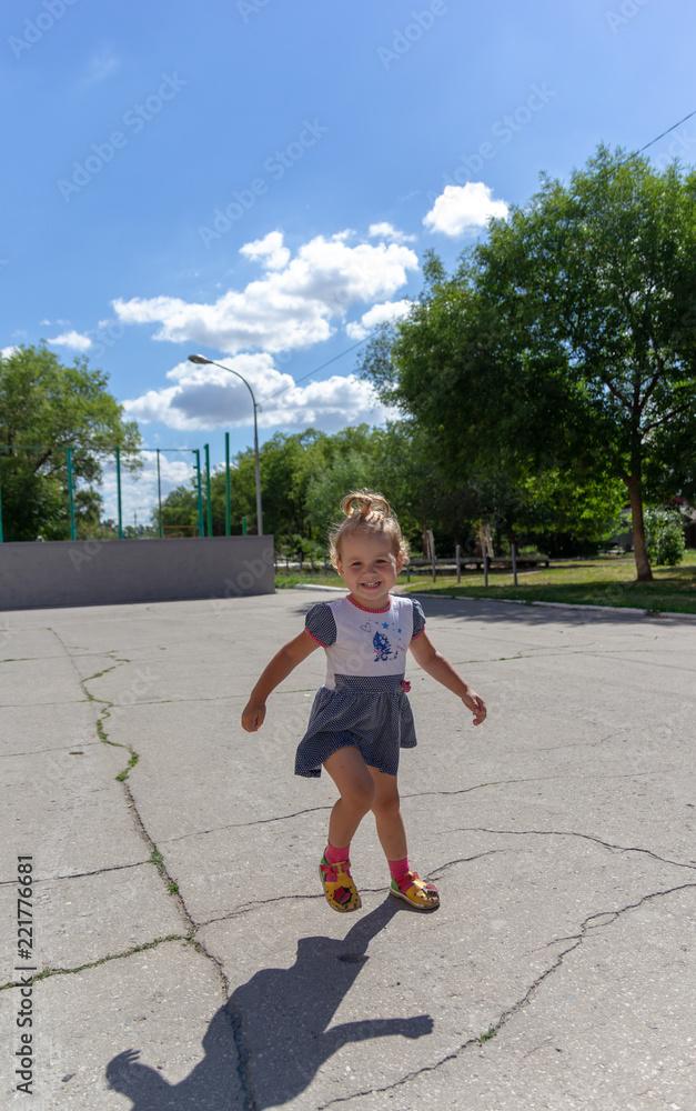 Beautiful cheerful child playing on a sunny summer day