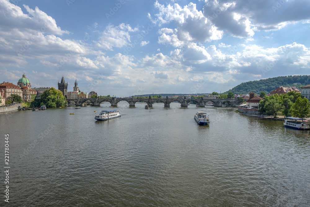 Beautiful summer day, Vltava river, ships and old city center, Prague, Czech Republic. Charles Bridge