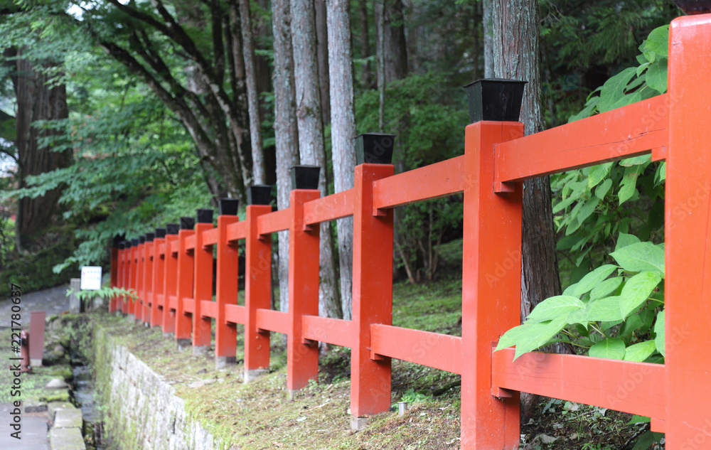 Closeup of red wooden fence in the park with natural background.