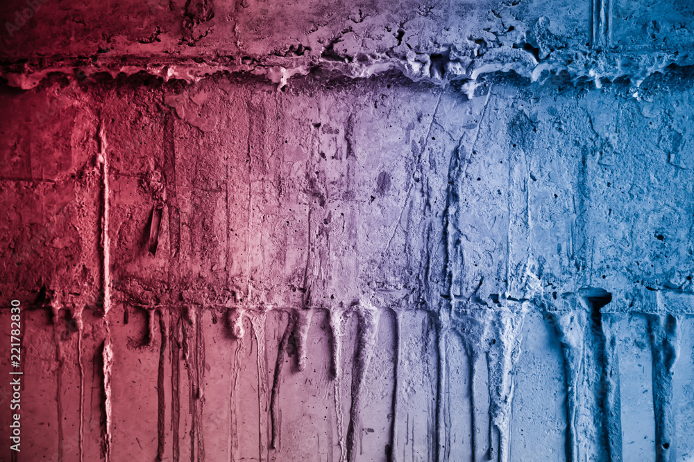 Textured broken cracked concrete wall, grunge background, red blue background Textured broken cracked concrete wall, grunge background, red blue background