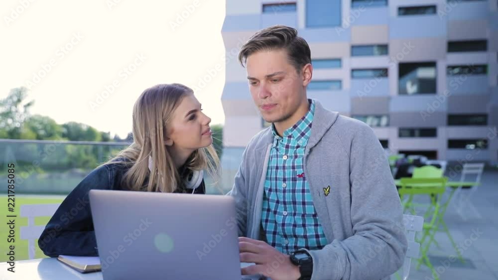 Young Man And Woman Working On Computer Outdoors Young Man And Woman Working On Computer Outdoors