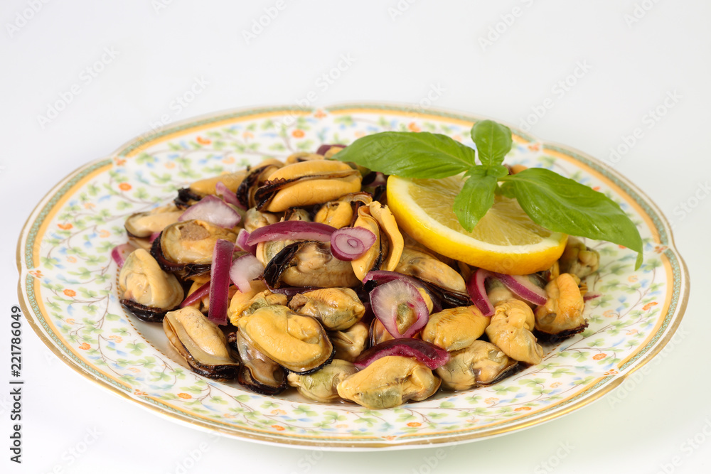 Homemade delicious summer salad with mussels, red onion, olive oil, lemon and basil Homemade delicious summer salad with mussels, red onion, olive oil, lemon and basil