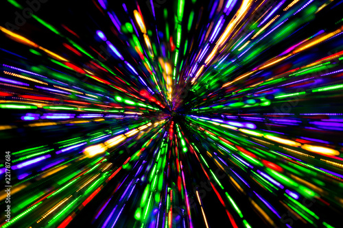 Diagonal blurred lines of color lights is converged on dark background. Colorful lights blurred by motion.