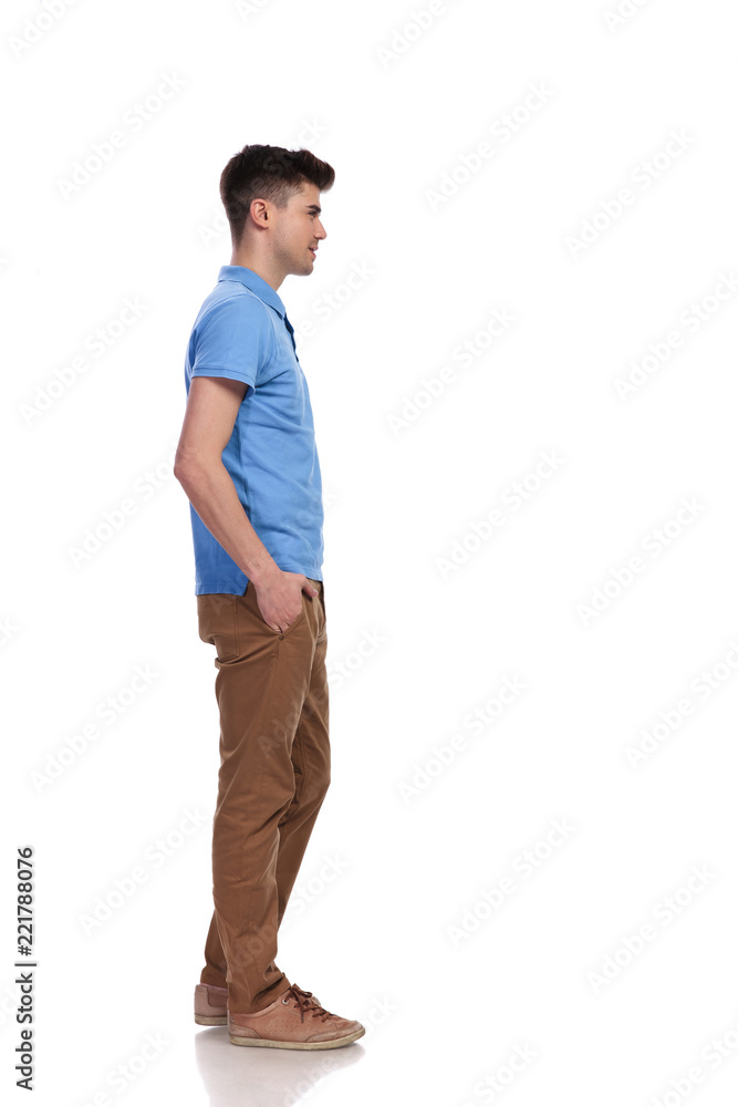 Fototapeta premium young casual man with hands in pockets waiting in line