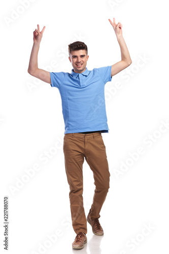 happy casual man celebrating success with hands in the air