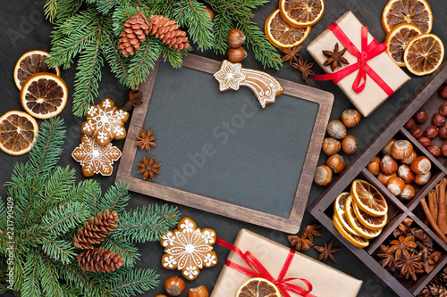 Christmas background with cookies, fir branches and spices