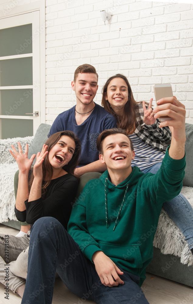 A company of teenagers makes selfies
