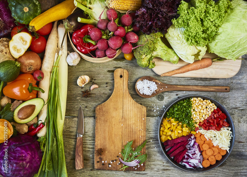 Fresh raw vegetables with cutting board on wooden background copy space for text. Design moce up photo