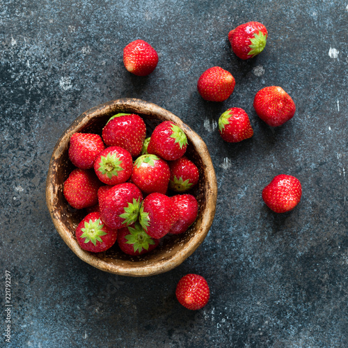 Fresh strawberries in a bowl. Top view, square crop. Healthy sweet food, dessert or snack