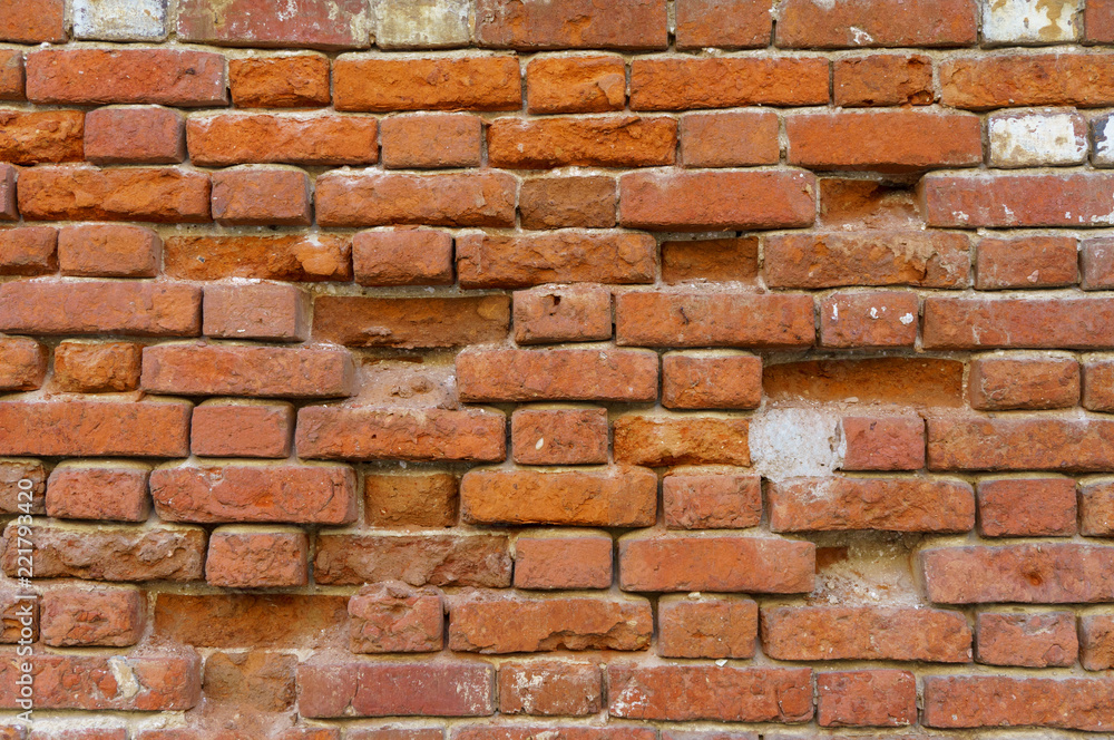 Obraz premium Background of old vintage dirty brick wall with peeling plaster, texture