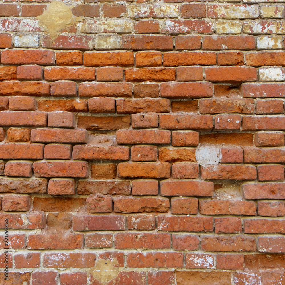 Fototapeta premium Background of old vintage dirty brick wall with peeling plaster, texture
