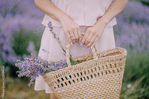 Fototapeta Naklejka Na Ścianę i Meble -  girl in hand holding bag with lavender