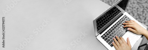 Website banner of laptop with female typing hands, copy space in grey color. Concept of blog header and advertisement of bitcoin and cryptocurrency, modern technology and copywriter occupation.