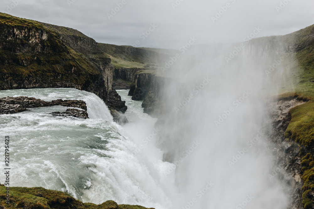 scenic view of steam above waterfall on beautiful Gullfoss waterfall in Iceland