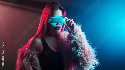 Beautiful young woman in virtual reality, the cyberpunk style, neon light, VR concept © Ulia Koltyrina