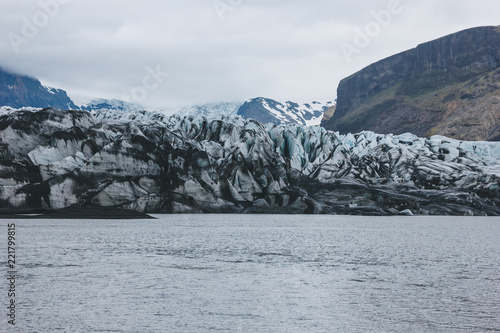 glacier Skaftafellsjkull and snowy mountains against cloudy sky in Skaftafell National Park in Iceland