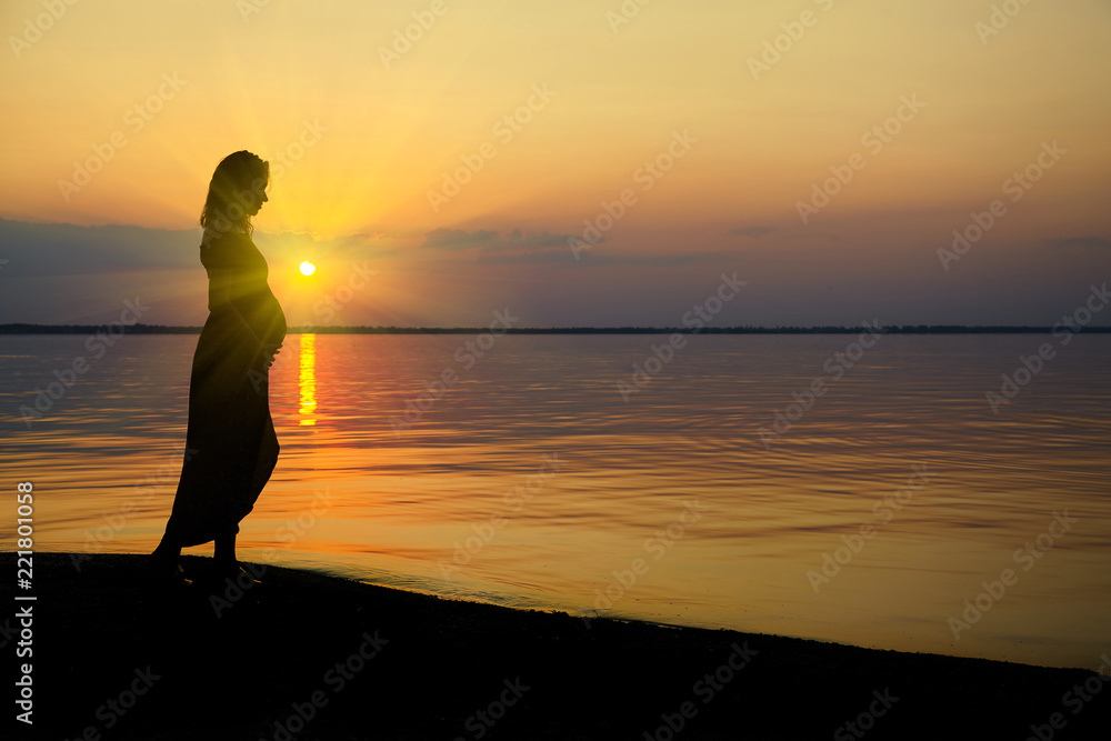 Pregnant woman on beach