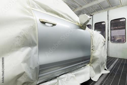 Auto body repair series: Closeup of grey SUV door in paint booth