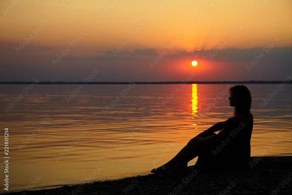 Woman on beach. Sunset at sea