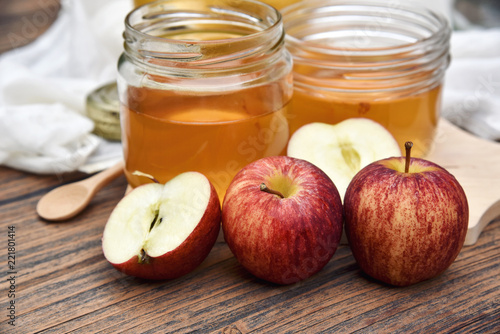Apple cider vinegar on wooden board, Kombucha tea with apple slices, Healthy probiotic nutrition drink for good balance digestive system.