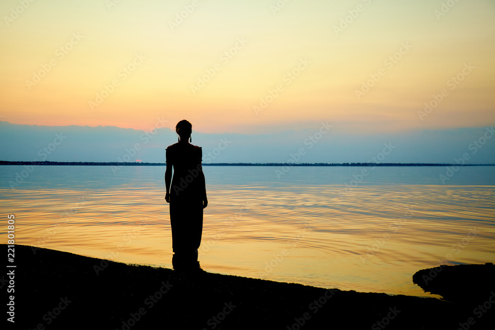 Woman on beach. Sunset at sea