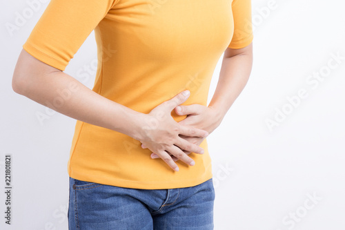 asian woman having stomachache on white background