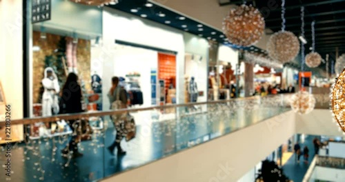 Blurry Christmas decorated shopping center with two floors and buyers. Crowd of people in Christmas black friday big sales, timelapse
