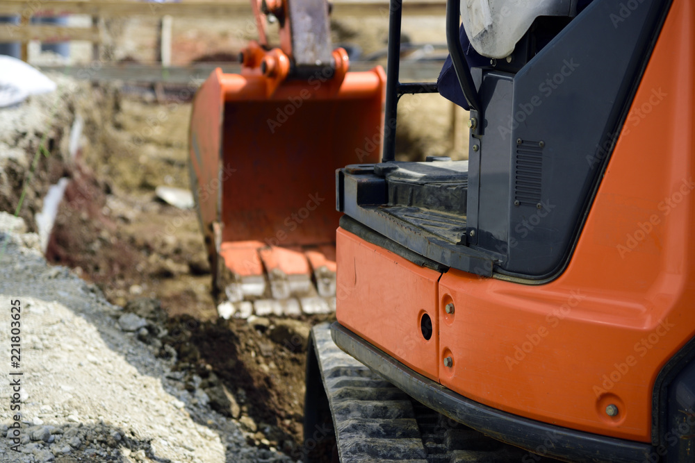 landscaping work; Backhoe to excavate the ground Stock Photo Adobe Stock