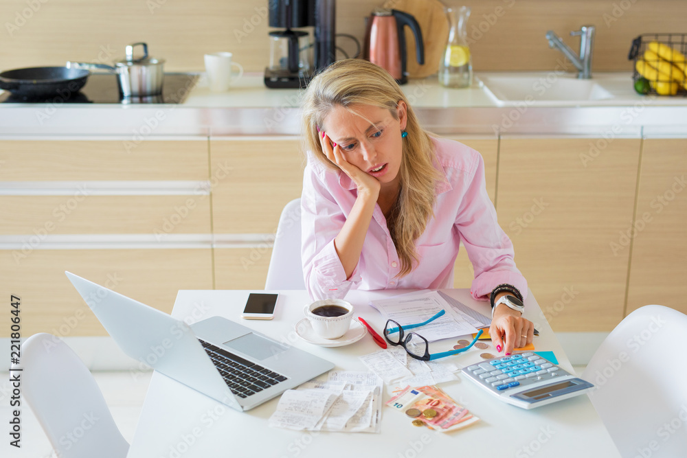 Stressed woman having financial problems and bills to pay Stressed woman having financial problems and bills to pay