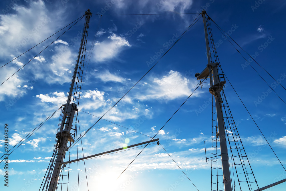 Two masts of a ship against the blue sky