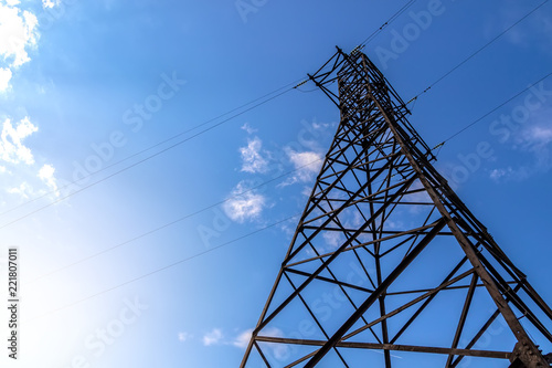 Power line support against blue sky background