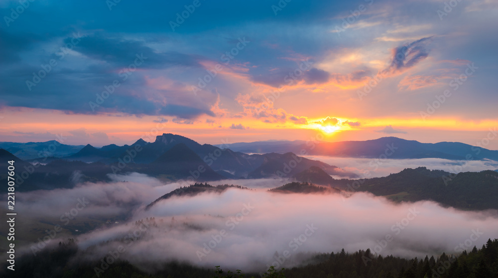 wonderful, beautiful sunset in the mountains. The fogs were illuminated by the setting sun