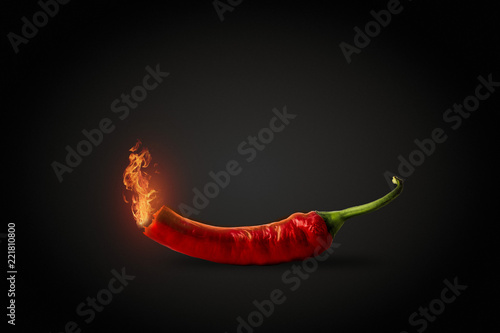 Red hot Chili pepper with fire coming out of it. Dark Black Back