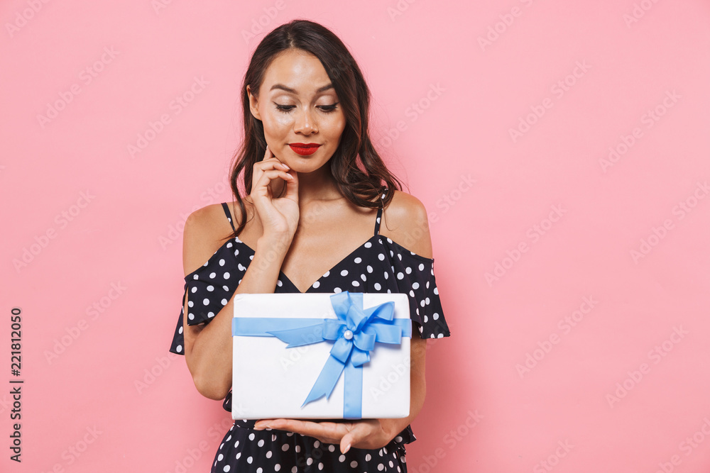 Woman isolated over pink background holding susprise gift box. Woman isolated over pink background holding susprise gift box.