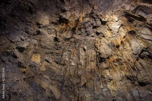 Underground abandoned gold iron ore mine shaft tunnel gallery passage with timbering wooden