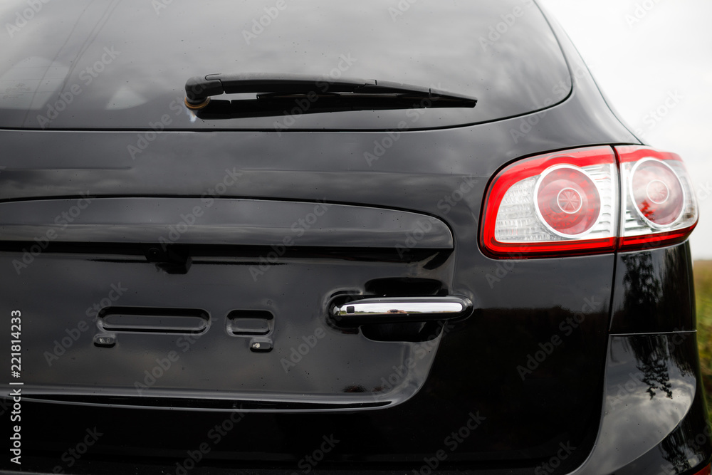 Black premium city crossover, luxury SUV rear light closeup.