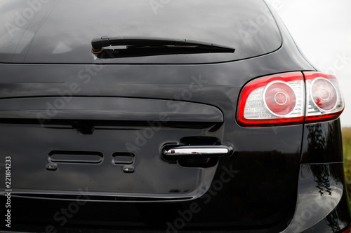 Black premium city crossover, luxury SUV rear light closeup. © VAKSMANV
