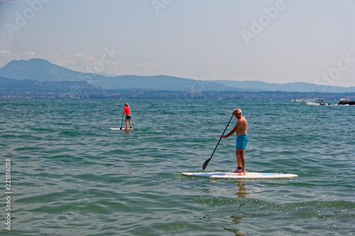 Sirmione, Italy 17 August 2018: Lake Garda. people on the surfboard.