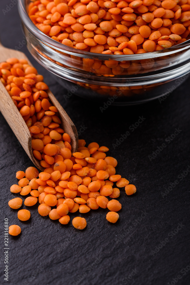 raw lentils on a dark stone background raw lentils on a dark stone background