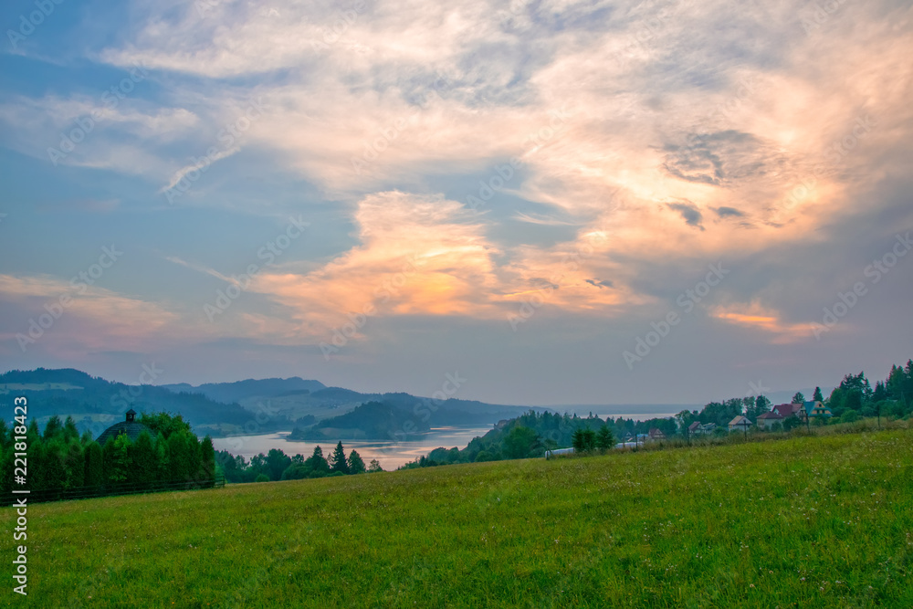 Obraz premium Rural landscape near artificial Czorsztynskie Lake in Southern Poland at sunset