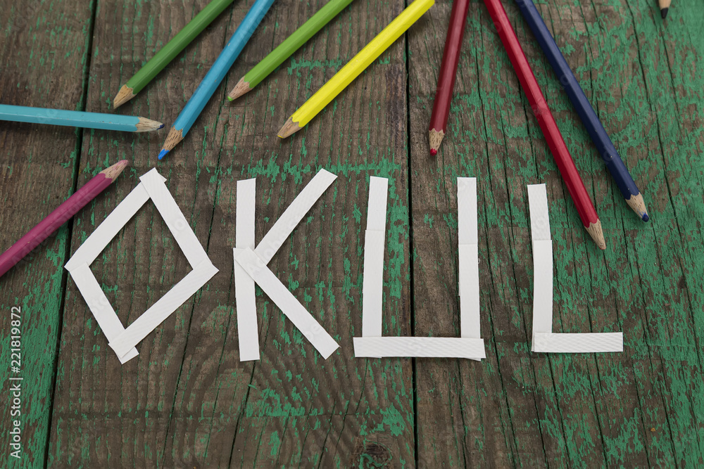write Okul with colorful pens on the green wooden background for education and back to school concept. write Okul with colorful pens on the green wooden background for education and back to school concept.