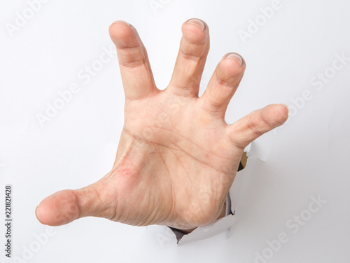 Male hand  punching through the paper photo