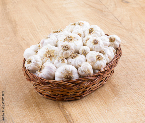 Pile of Fresh Organic Garlic on Vintage Wooden Background photo