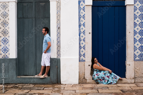 Happy couple in front of the blue doors in a historical city.