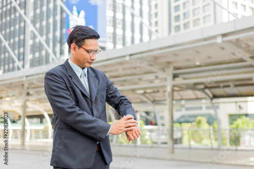 Young Asia handsome businessman looking at his watch