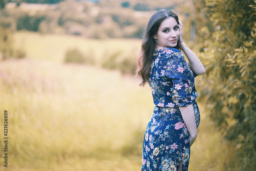 Pregnant girl in a dress in nature Pregnant girl in a dress in nature