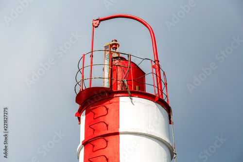 Red and white lighthouse at the Krestovsky island in St. Petersburg, Russia photo