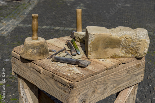 Stonemason tools hammer and chisel outdoors.